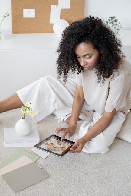 pexels-photo-7552372-7552372 Creative woman using a tablet for design planning in a modern, relaxed setting.